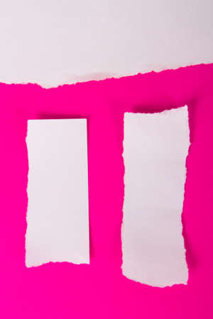 Collection of white torn pieces of paper on pink background, ready for your messages.の写真素材