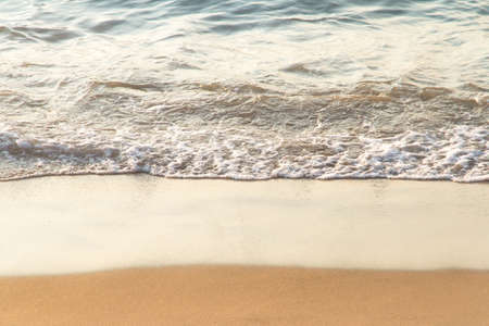 Soft wave of the sea on sandy beach with space.の写真素材