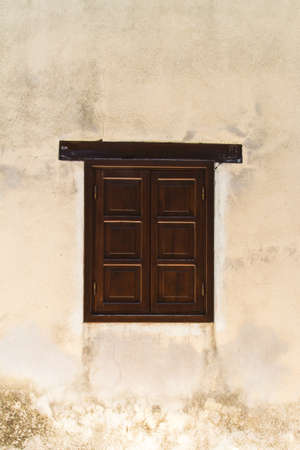 Close up view of closed window on stone wall.の写真素材