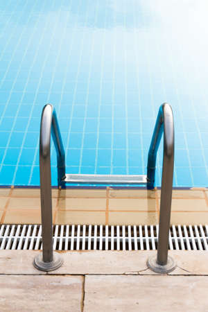 Back view of stair of blue swimming pool.の写真素材