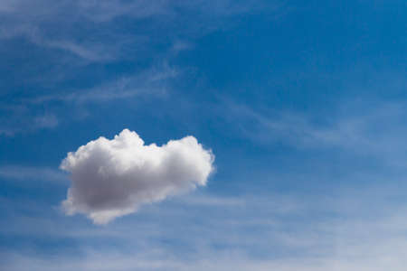 Single white cloud in blue sky.の写真素材