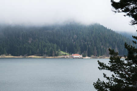 Landscape view of lake with mystical foggy hill in Lake Abant, Bolu, Turkey.の写真素材