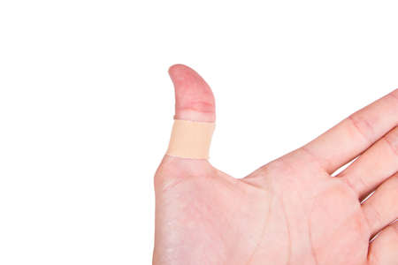 Adhesive bandage, plaster on thumb, isolated on white background.の写真素材