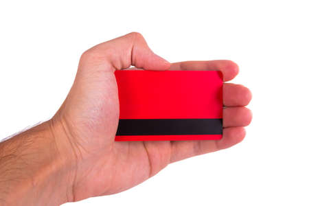 Hand holding red credit card, isolated on white background.の写真素材