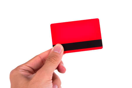 Hand holding red credit card, isolated on white background.の写真素材