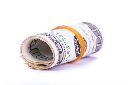 Roll of one hundred dollar banknotes, isolated on white background.の写真素材