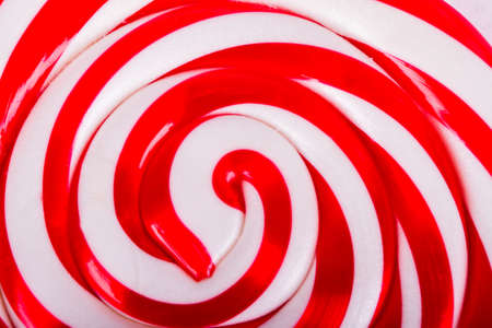 Red and white spiral lollipop candy as background.の写真素材