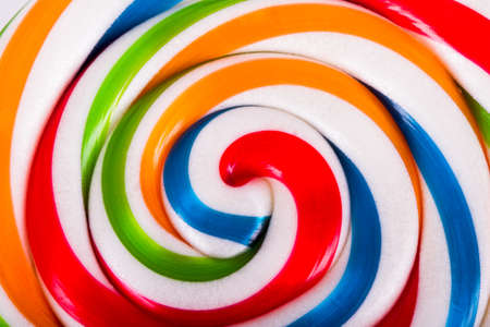 Colorful spiral lollipop candy as background.の写真素材