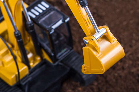 Construction machine, detail view of excavator on pile of soil.の写真素材