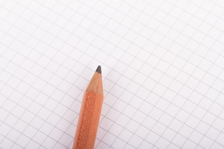 Pencil on blank, white notebook with copyspace.
