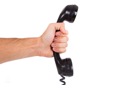 Hand holding vintage phone receiver, isolated on white .の写真素材