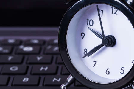 Deadline concept, alarm clock on laptop.の写真素材