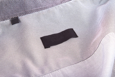 Close up view of blank black label in shirt.
