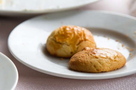 Cookie pieces in  white plate on table.の写真素材