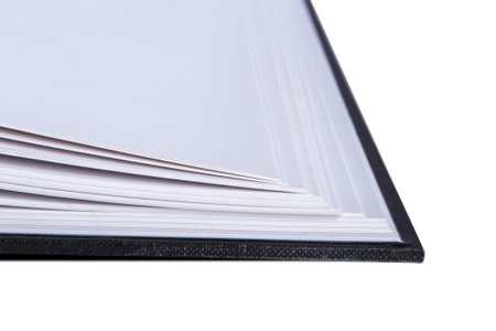 Close up view of opened book corner, isolated on white background.