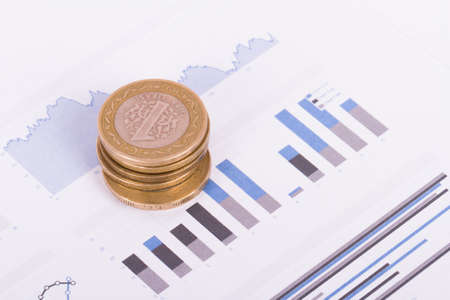 Financial chart with dollar banknotes and coins.の写真素材