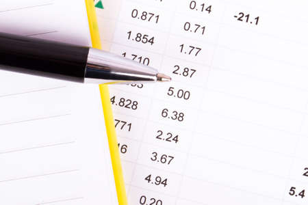 Financial data analysis with notebook and pen, top view.の写真素材
