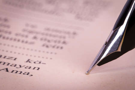 Close up view of fountain pen on old history book.の写真素材