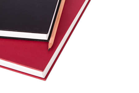 Stack of black and red books with pencil, isolated on white background.