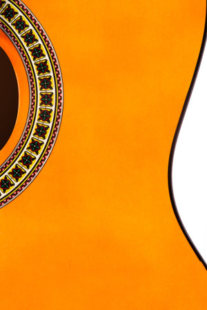 Detail of orange wooden classical acoustic guitar.