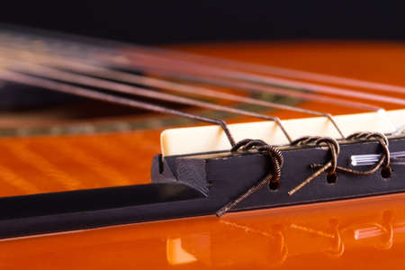 Detail view of orange wooden classical acoustic guitar.の写真素材