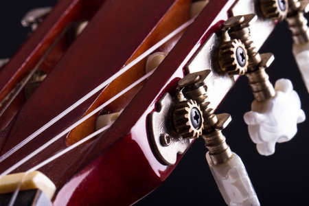 Close up view of fingerboard on classic guitar over black background.の写真素材