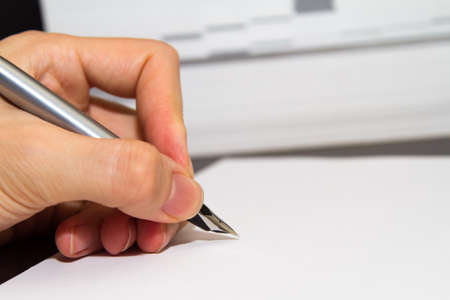 Hand writing with fountain pen on paper.の写真素材