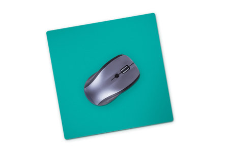 Wireless computer mouse with green pad, isolated on white background.