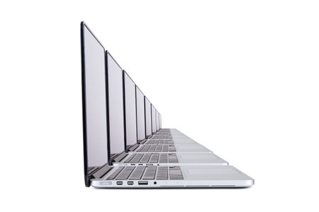 Laptops in row, isolated on white background.