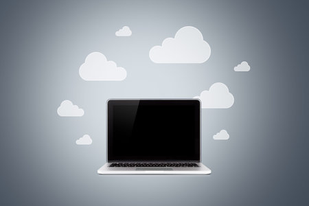Laptop with blank screen and cloud technology icons around on dark background.