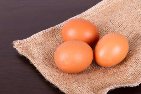 Healthy organic eggs with protein on sackcloth and wooden table.の写真素材