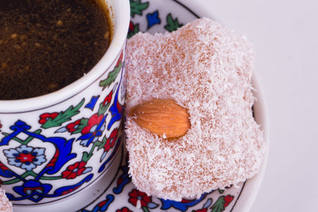 Delicious Turkish delights with coffee, isolated on white background.の写真素材