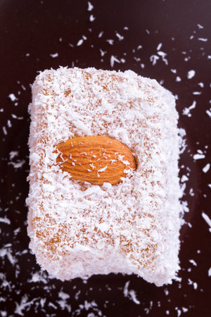 Single Turkish delight in brown bowl.