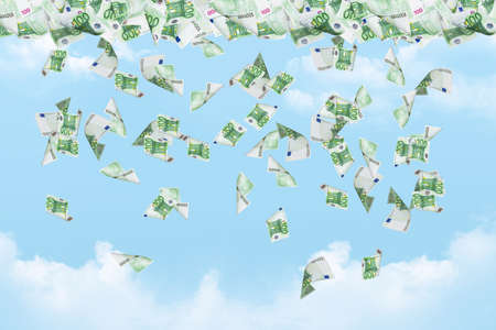 Dollar banknotes falling down on cloudy sky background.の写真素材
