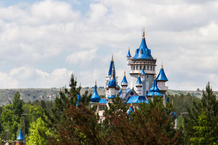 Fairytale castle in park on cloudy background.のeditorial素材
