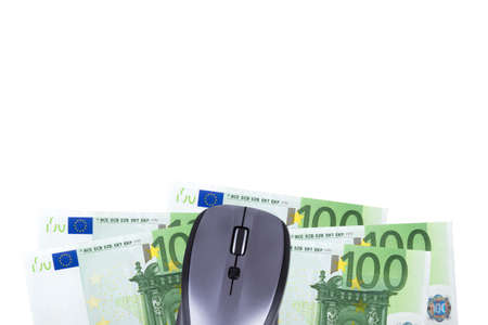 Finance concept, euro banknotes under computer mouse with copy space for your design, isolated on white background.の写真素材