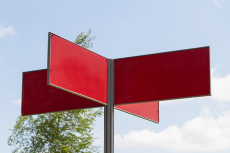 Blank cross traffic sign on cloudy background.の写真素材
