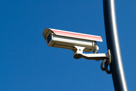 Security camera on blue sky.