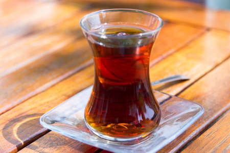 Close up view, glass of tea on wooden table.の写真素材