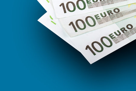 Finance money concept, banknot of one hundred euros, isolated on blue background.