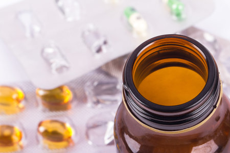 Close-up empty brown medical / pill bottle with top view, isolated on white background.の写真素材