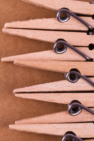 Detailed close up top view of wooden clothespins, on paperboard background.の写真素材