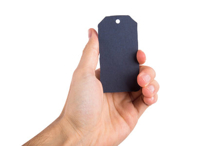 Front view of rectangle black label with rope, holding on hand, isolated on white background.