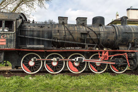 Front view of black old train wagon, in cloudy sky.のeditorial素材