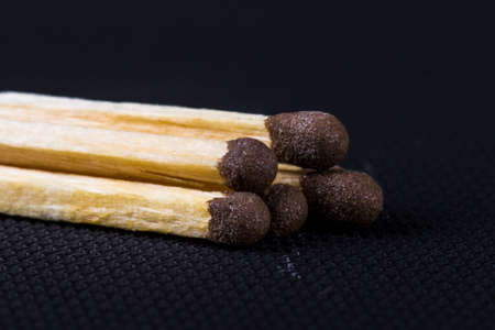 Close up detailed front view of matches, on black background.の写真素材