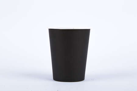 Close up detailed front view of one recycled black standing paper glass, isolated on white background.の写真素材