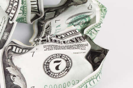 Close up detailed top view of crumpled one hundred dollar bannotes, isolated on white background.の写真素材