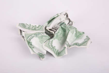 Close up detailed top view of crumpled one hundred dollar bannotes, isolated on white background.の写真素材