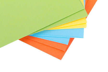 Close up detailed top view of heap of multicolored envelopes on end, isolated on white background.