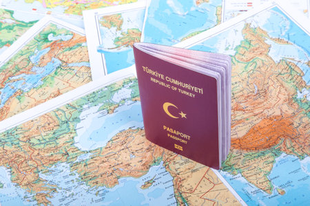 Close up detailed view of a Turkish passport standing on a world map.